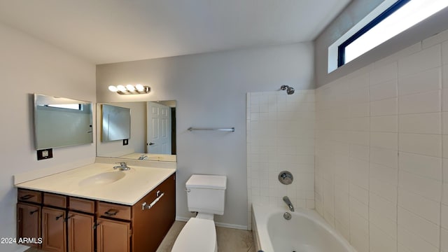 full bathroom featuring vanity, toilet, and tiled shower / bath