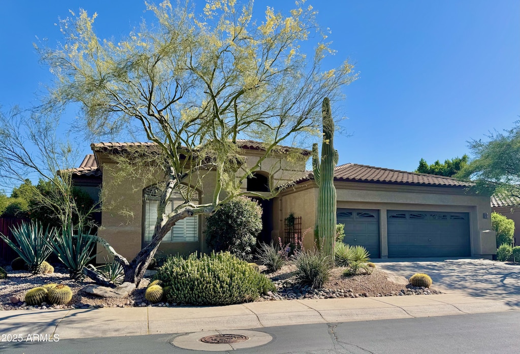5149 E Silver Sage Ln, Cave Creek, AZ 85331 - view of front of property featuring an attached garage, stucco siding, concrete driveway, and a tiled roof