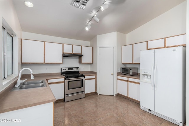 kitchen featuring white cabinetry, lofted ceiling, stainless steel appliances, and sink