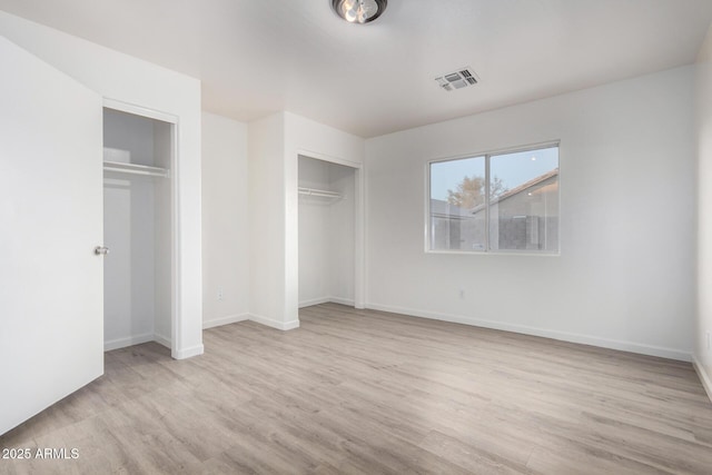 unfurnished bedroom with light wood-type flooring