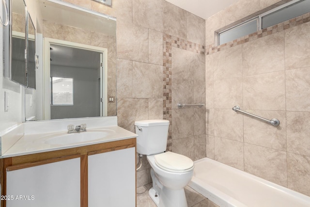 bathroom featuring vanity, a tile shower, tile walls, and toilet