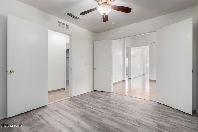 empty room featuring light hardwood / wood-style flooring and ceiling fan