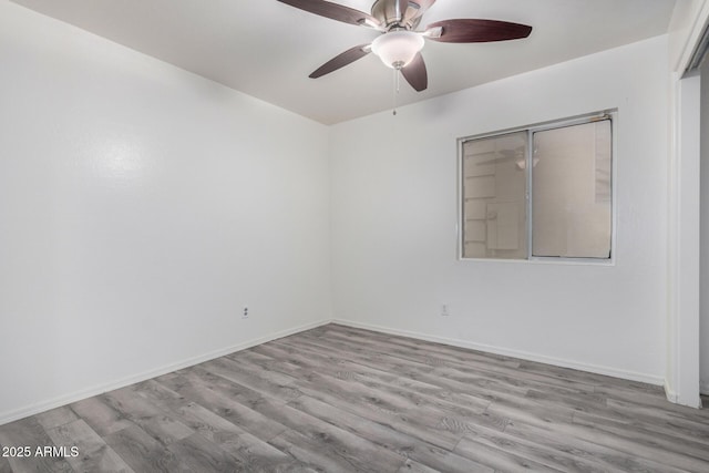 spare room with light hardwood / wood-style flooring and ceiling fan