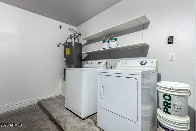 clothes washing area featuring washer and clothes dryer and electric water heater