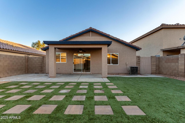 back of house featuring a yard, central AC unit, and a patio