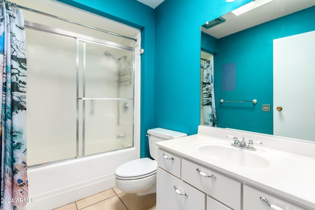 full bathroom featuring tile patterned flooring, vanity, enclosed tub / shower combo, and toilet