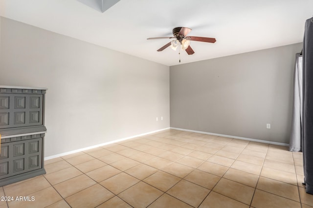 tiled empty room with ceiling fan