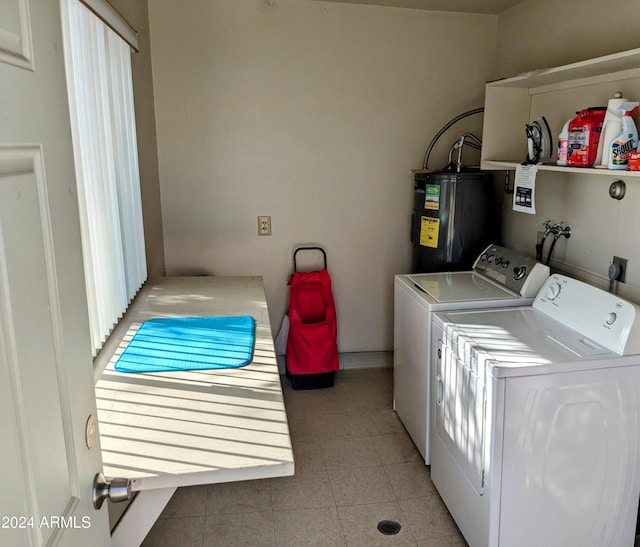 clothes washing area with separate washer and dryer and electric water heater