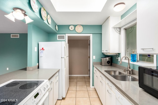 kitchen featuring white cabinetry, sink, light tile patterned floors, and white appliances