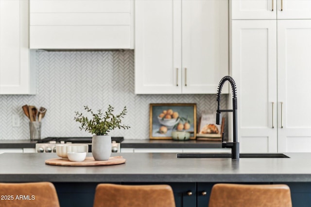 kitchen with white cabinetry, sink, and decorative backsplash