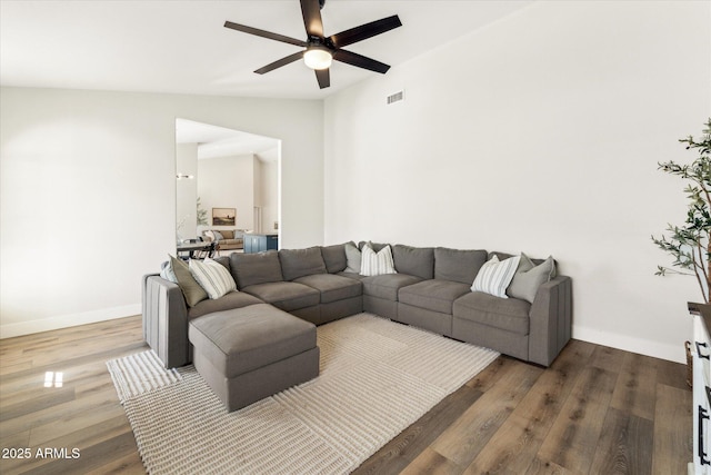 living room featuring vaulted ceiling, hardwood / wood-style floors, and ceiling fan