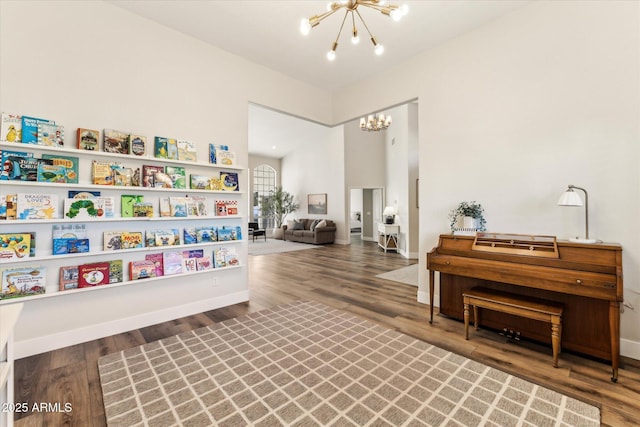 living area featuring wood-type flooring and a chandelier