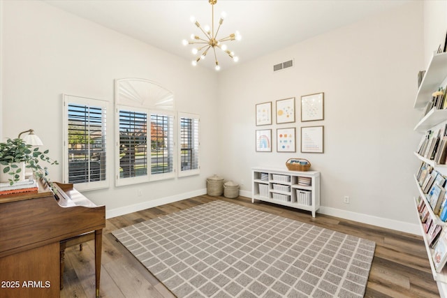 sitting room with dark hardwood / wood-style floors and a chandelier