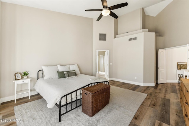 bedroom with ceiling fan, high vaulted ceiling, and dark hardwood / wood-style flooring