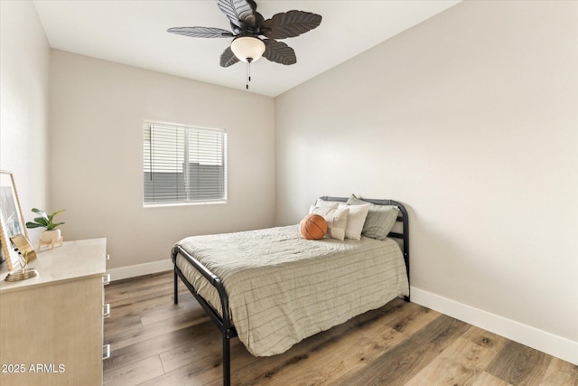 bedroom with ceiling fan and wood-type flooring