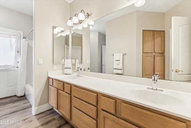 bathroom with wood-type flooring, shower / tub combo, and vanity