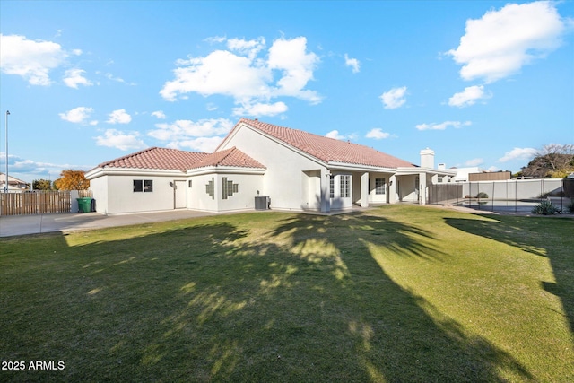 back of house featuring a patio area, central air condition unit, and a lawn