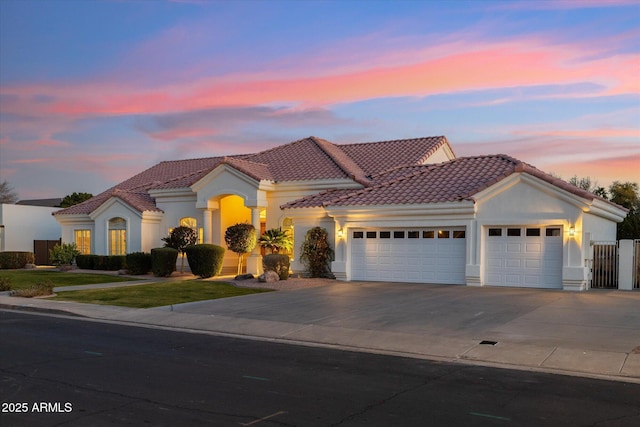 mediterranean / spanish house with a garage