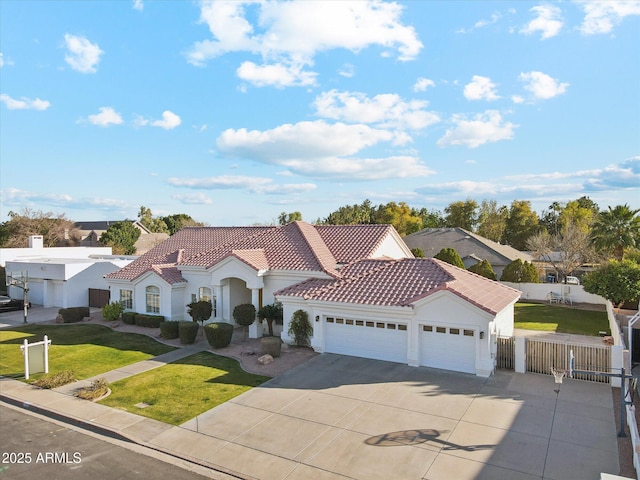 mediterranean / spanish-style home with a garage and a front lawn