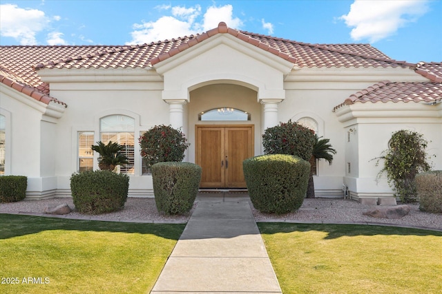 mediterranean / spanish home featuring a front lawn