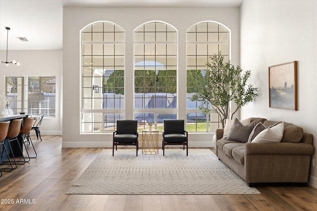 living room featuring an inviting chandelier and hardwood / wood-style floors