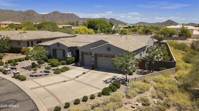 view of front of home with a mountain view and a garage