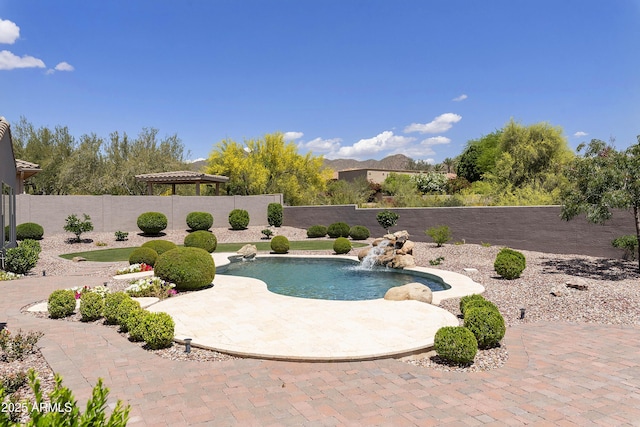 view of swimming pool with pool water feature and a patio