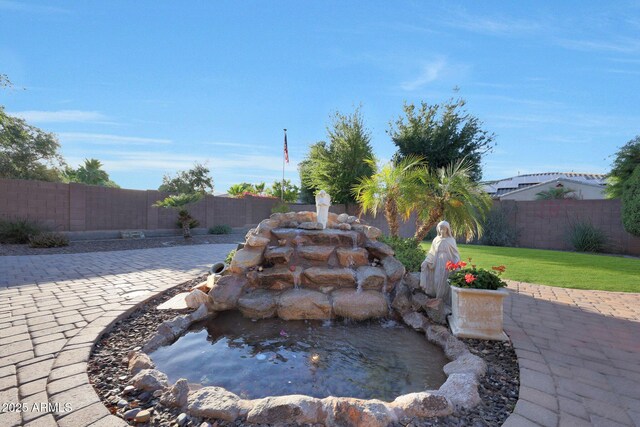 19334 W Pasadena Ave, Litchfield Park, AZ 85340 - exterior view of a fenced backyard and a garden pond