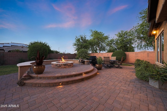 19334 W Pasadena Ave, Litchfield Park, AZ 85340 - view of patio / terrace with a fire pit, a fenced backyard, and outdoor dining area