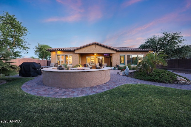 19334 W Pasadena Ave, Litchfield Park, AZ 85340 - back of property featuring stucco siding, a tile roof, and a patio area