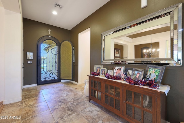 19334 W Pasadena Ave, Litchfield Park, AZ 85340 - entryway featuring a chandelier, baseboards, and arched walkways