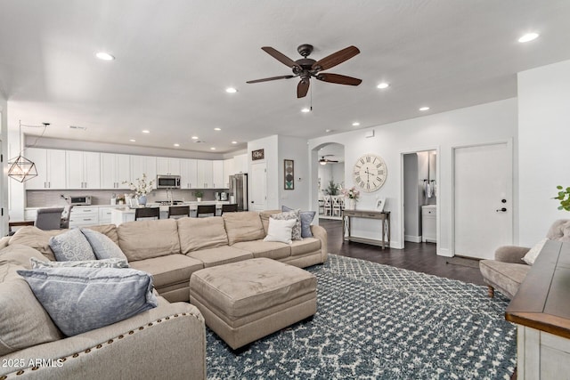 1342 E Jade Dr, Chandler, AZ 85286 - living area featuring ceiling fan, dark wood-style floors, recessed lighting, and arched walkways