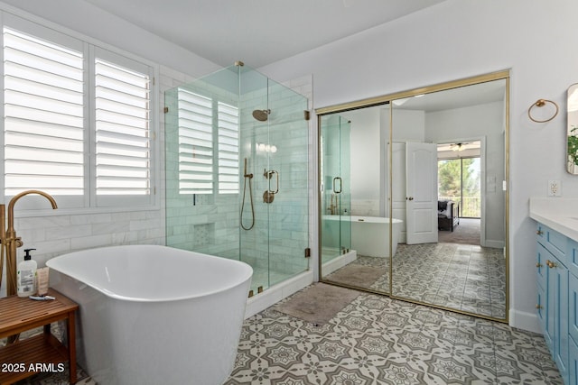 1342 E Jade Dr, Chandler, AZ 85286 - full bathroom featuring vanity, a shower stall, a freestanding bath, and tile walls