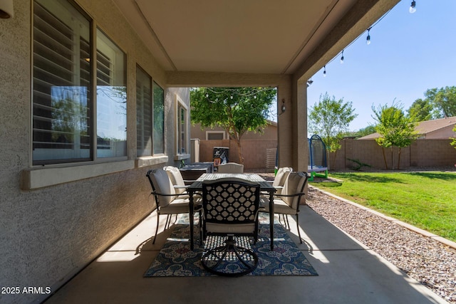 1342 E Jade Dr, Chandler, AZ 85286 - fenced backyard featuring a trampoline, outdoor dining area, and a patio area