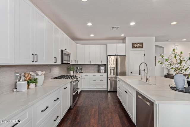 1342 E Jade Dr, Chandler, AZ 85286 - kitchen with stainless steel appliances, dark wood finished floors, white cabinetry, and recessed lighting