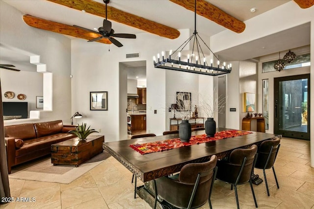 dining room with beamed ceiling and ceiling fan with notable chandelier