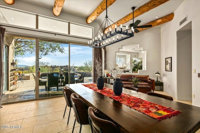 dining room with a ceiling fan, beam ceiling, visible vents, and a high ceiling