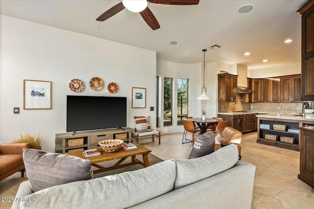 living room featuring ceiling fan, visible vents, and recessed lighting