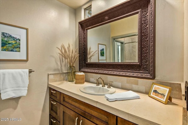 bathroom featuring vanity and decorative backsplash