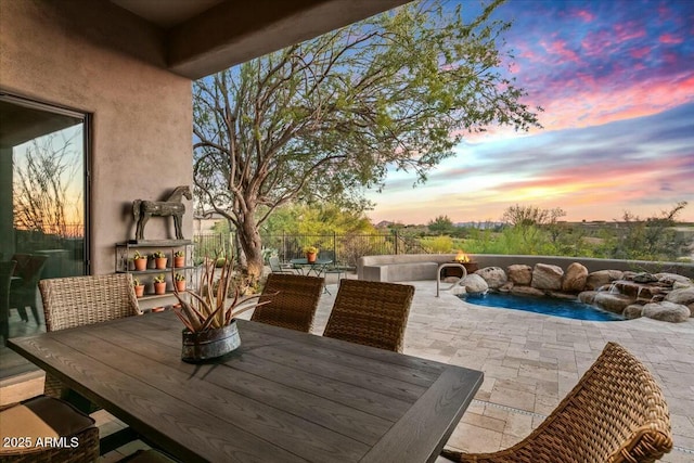 view of patio featuring outdoor dining area and an outdoor pool