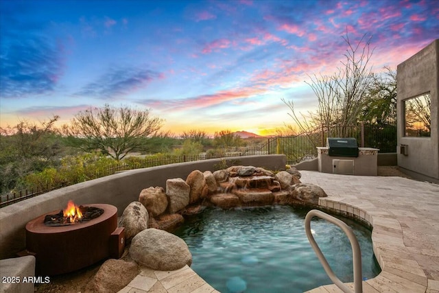 view of swimming pool featuring a fenced backyard, grilling area, a fenced in pool, and area for grilling