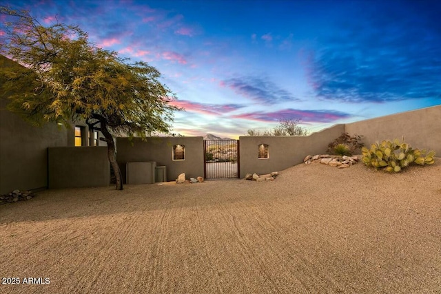 view of yard featuring fence and a gate