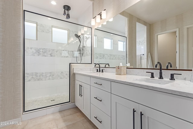 bathroom with vanity and tiled shower