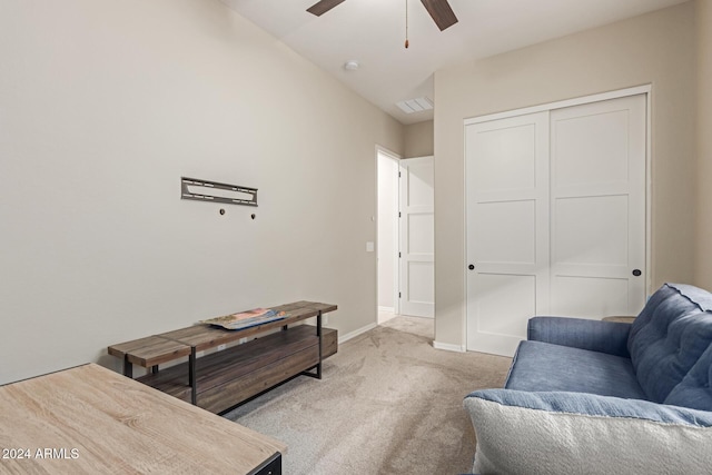 carpeted living room with ceiling fan