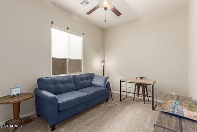 living room with ceiling fan and carpet