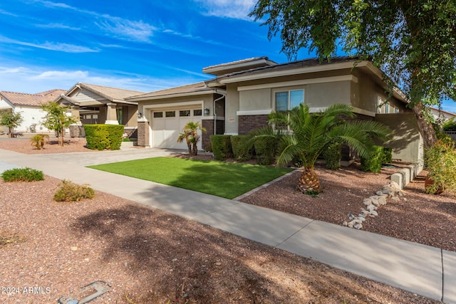 view of front of property with a garage and a front lawn