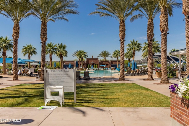 exterior space with a community pool and a yard