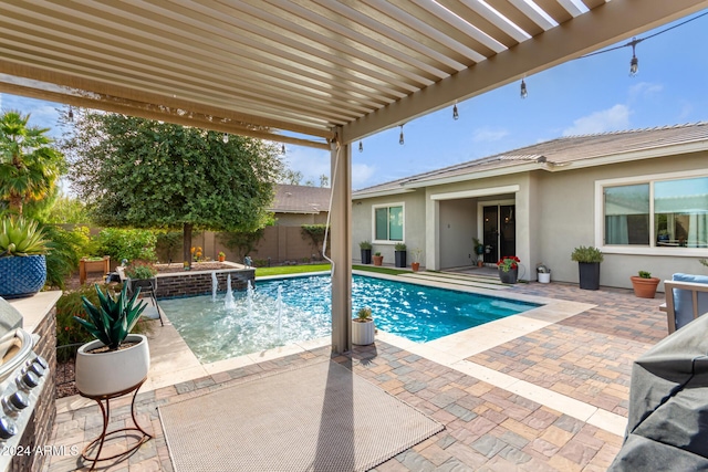 view of pool with pool water feature, a patio area, and a pergola