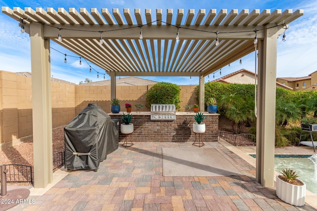 view of patio with a pergola, a fenced in pool, and area for grilling