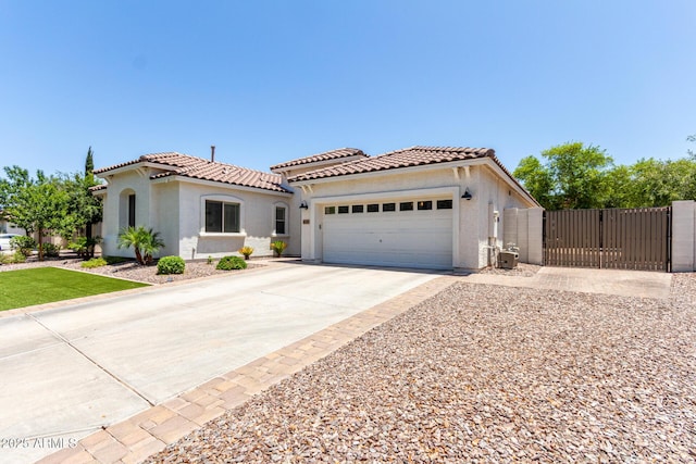 6317 S Banning St, Gilbert, AZ 85298 - mediterranean / spanish-style home featuring a gate, stucco siding, a tiled roof, and a garage